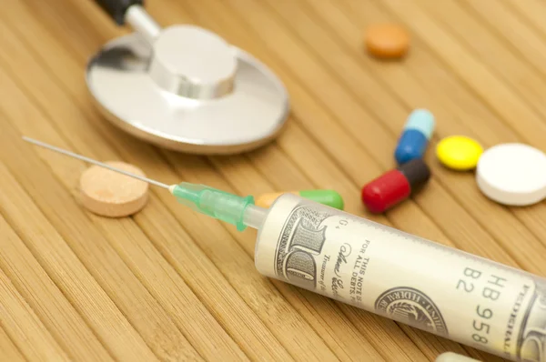 Money in syringe — Stock Photo, Image