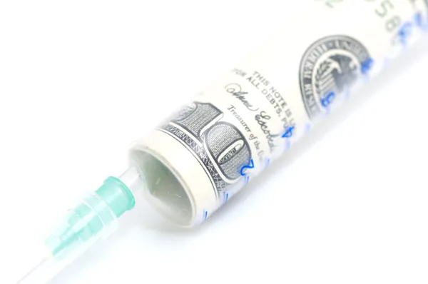 Money in syringe on white background — Stock Photo, Image