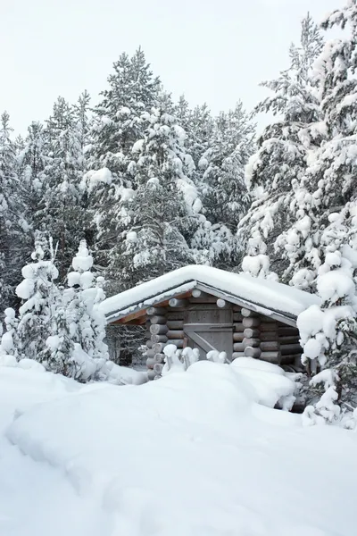 Small wooden blockhouse in the snow — Stock Photo, Image