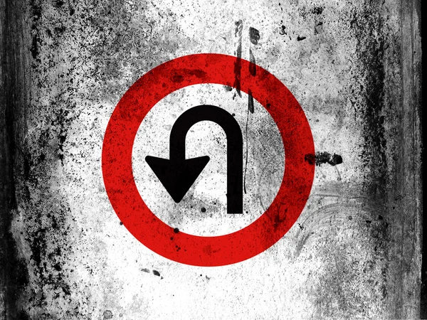 U turn road sign painted on board with grungy dirty stains all over it
