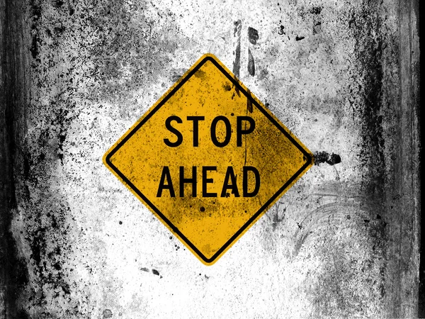 Stop ahead road sign painted on board with grungy dirty stains all over it — Stock Photo, Image