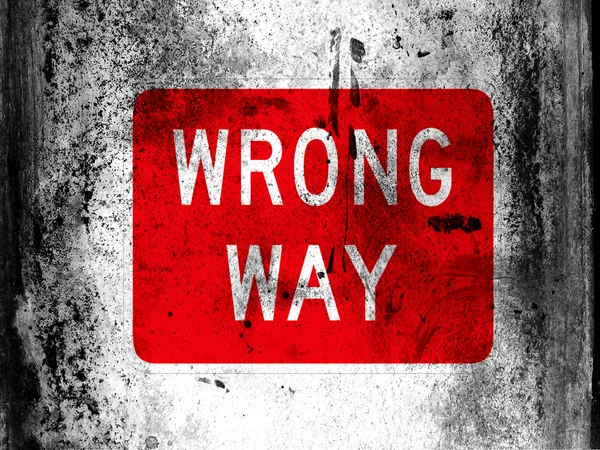 Wrong way road sign painted on board with grungy dirty stains all over it