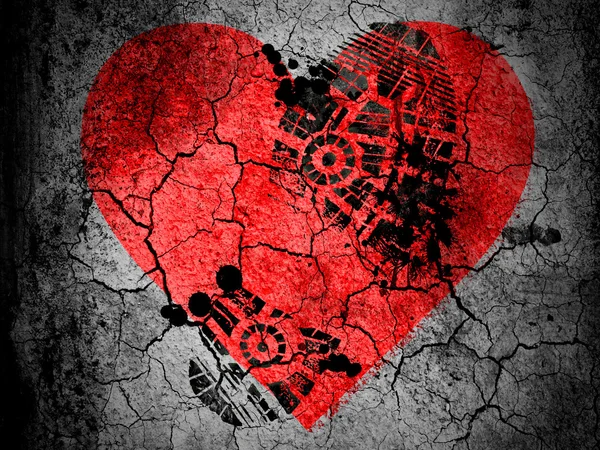 Red Heart symbol painted on cracked ground with vignette with dirty oil footprint over it — Stock Photo, Image