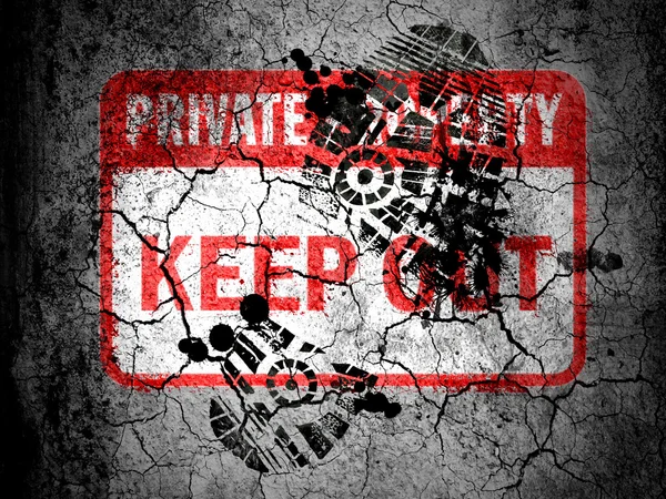 Keep out sign painted on cracked ground with vignette with dirty oil footprint over it — Stock Photo, Image