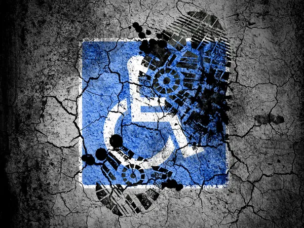 Disabled road sign painted on cracked ground with vignette with dirty oil footprint over it — Stock Photo, Image