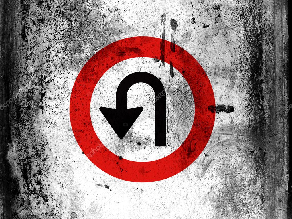 U turn road sign painted on board with grungy dirty stains all over it