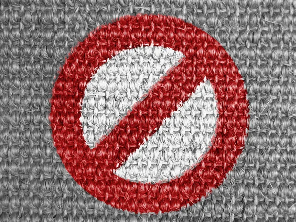 Forbidden sign painted on grey fabric — Stock Photo, Image