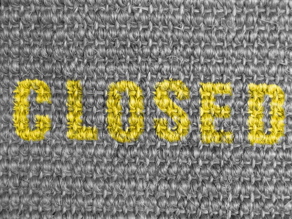 Closed caption painted on grey fabric