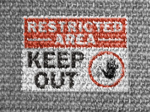 Restricted area sign painted on grey fabric — Stock Photo, Image