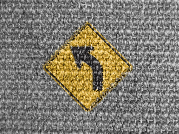 Turn road sign painted on grey fabric — Stock Photo, Image