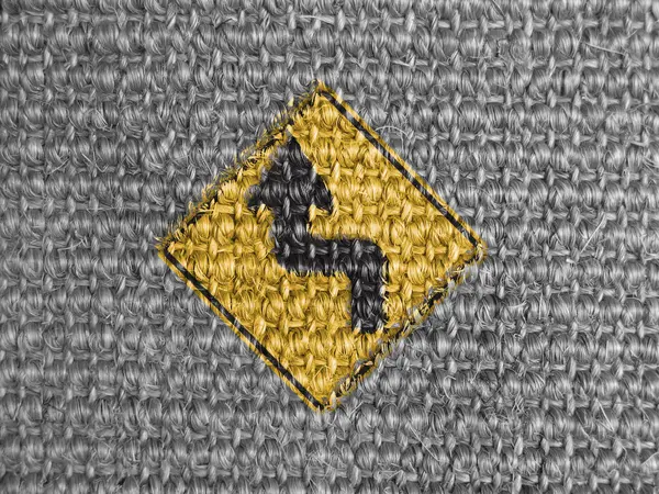 Turn road sign painted on grey fabric — Stock Photo, Image