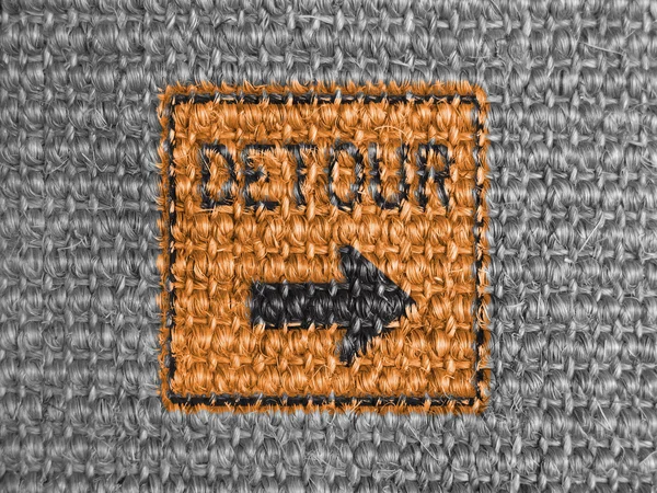 Detour road sign painted on grey fabric — Stock Photo, Image