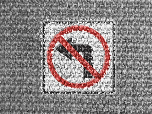 No left turn road sign painted on grey fabric — Stock Photo, Image