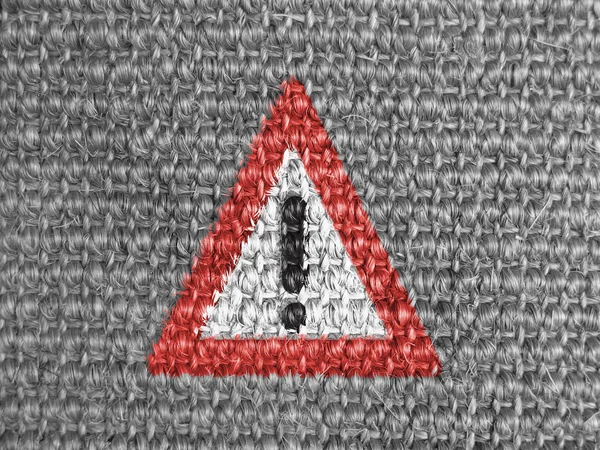 Warning road sign painted on grey fabric — Stock Photo, Image