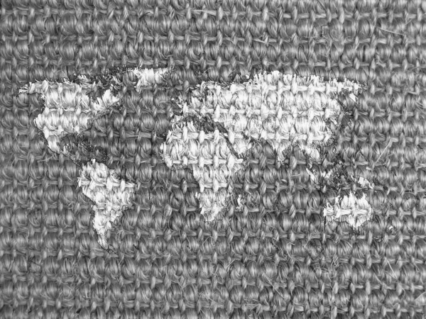 World map drawn on grey fabric