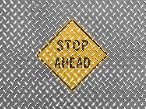 Stop ahead road sign painted on metal floor — Stock Photo, Image