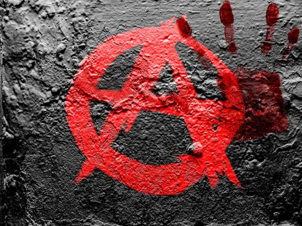 Anarchy symbol painted on grunge wall with bloody palmprint over it — Stock Photo, Image