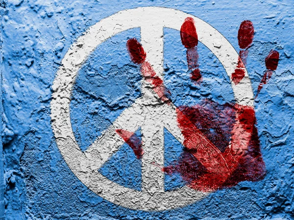 Peace symbol painted on grunge wall with bloody palmprint over it — Stock Photo, Image