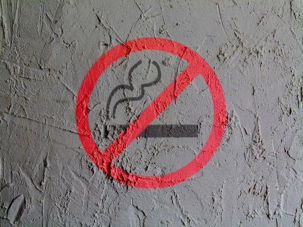 На стене нарисован знак, запрещающий курение — стоковое фото