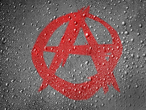 Anarchy symbol painted on metal surface covered with rain drops — Stock Photo, Image