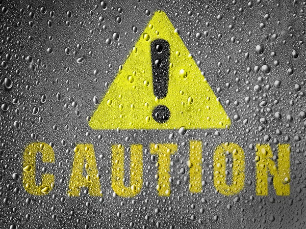 Caution sign painted on metal surface covered with rain drops — Stock Photo, Image