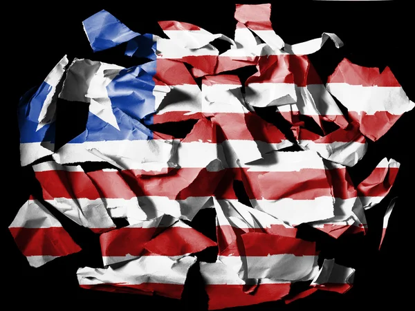Liberia. Liberian flag painted on pieces of torn paper on black background — Stock Photo, Image
