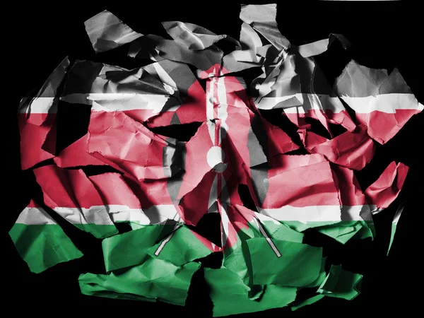 Kenyas flagga målade på rivna pappersbitar på svart bakgrund — Stockfoto