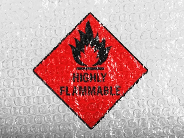 Highly flammable sign drawn on painted on bubblewrap — Stock Photo, Image