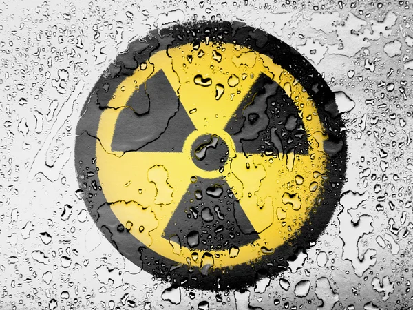 Nuclear radiation symbol painted on covered with water drops — Stock Photo, Image