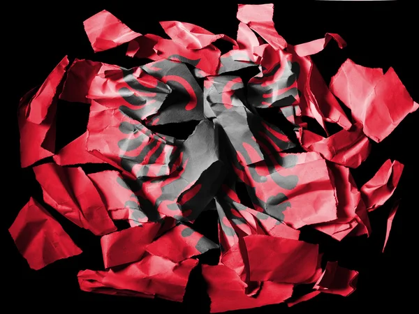 Albania. Albanian flag painted on pieces of torn paper on black background — Stock Photo, Image