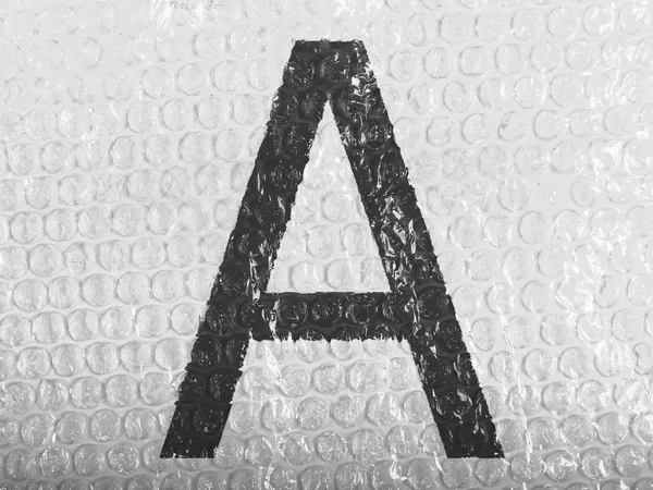 A letter painted on bubblewrap — Stock Photo, Image