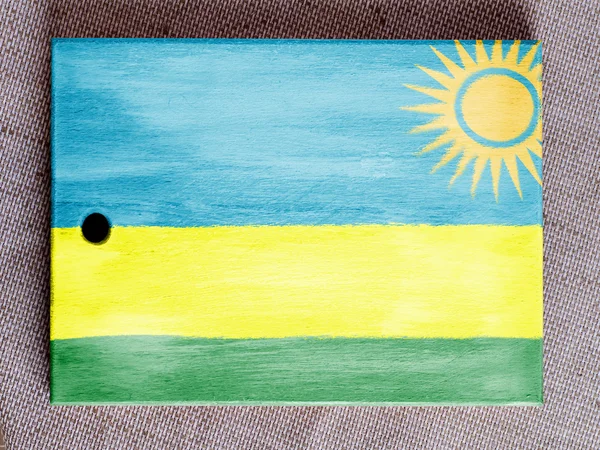 Rwanda flagga målade över träskiva — Stockfoto