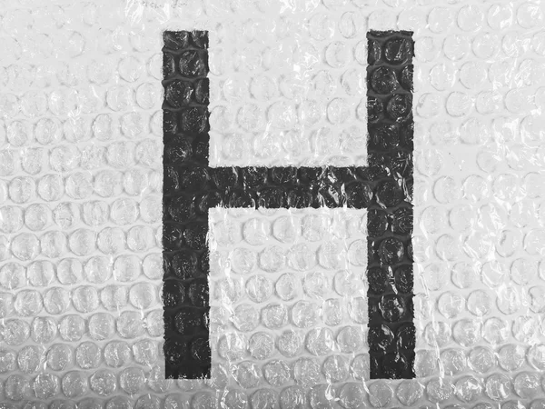 単 bubblewrap に描かれた h の手紙 — ストック写真