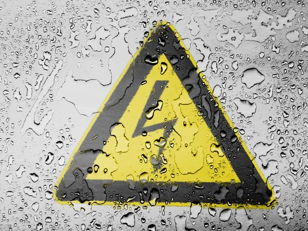 Electric shock sign painted on covered with water drops — Stock Photo, Image