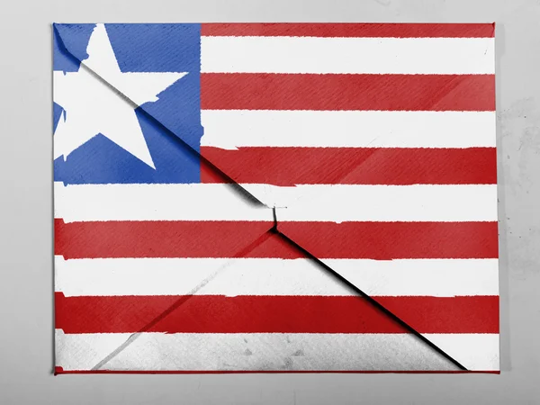Liberya. Liberya bayrağı gri zarfın üzerine boyalı — Stok fotoğraf