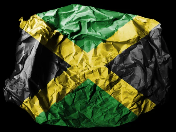 Bandeira da Jamaica pintada em papel amassado sobre fundo preto — Fotografia de Stock
