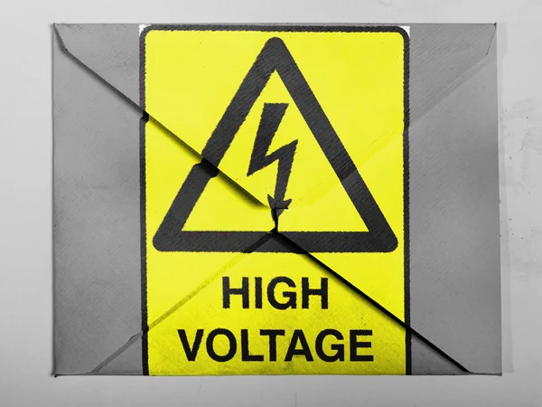 High voltage sign drawn at painted on grey envelope — Stock Photo, Image