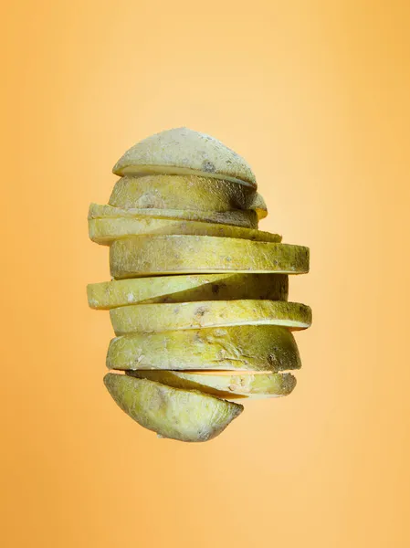 Potato slices floating on orange Stock Photo