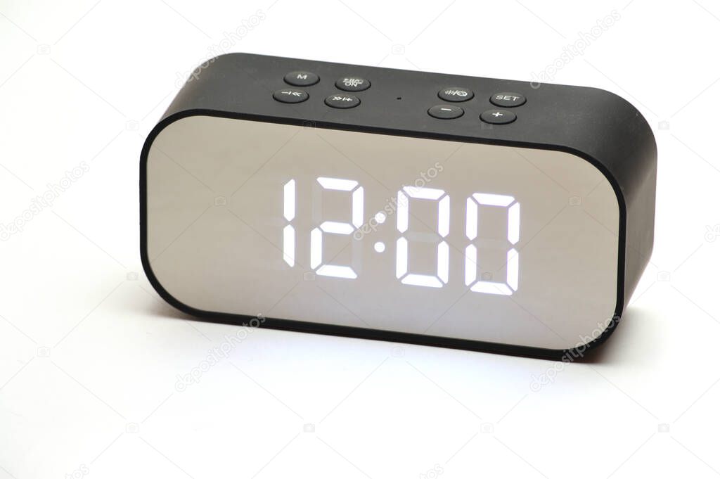 Electronic clock with time 12 hours 00 minutes on an isolated white background