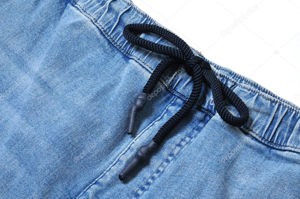 Vintage jeans with drawstring on isolated white backgroun