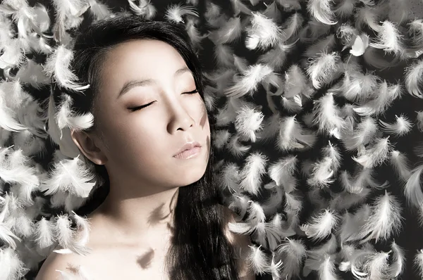 Girl with feathers — Stock Photo, Image