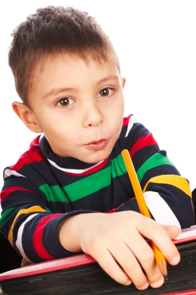 Menino com livro e lápis — Fotografia de Stock