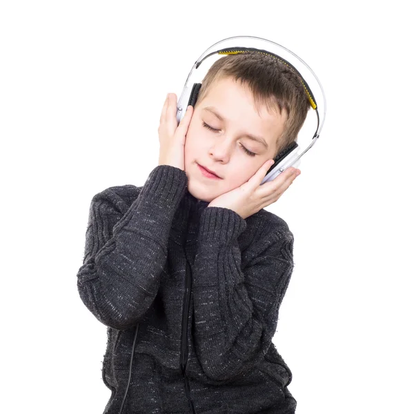 Close up portrait of eyes closed boy listening to music with hea — Stock Photo, Image
