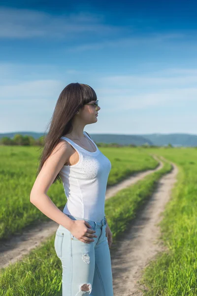Portrait of beautiful confident girl walking on the field — Stock Photo, Image