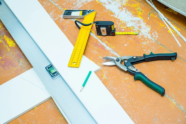 Set of tools over a wood floor with sawdust — Stock Photo, Image