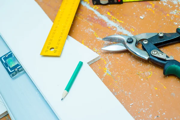 Set of tools over a wood floor with sawdust — Stock Photo, Image