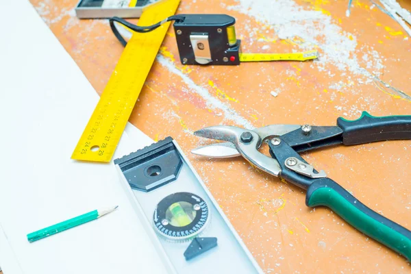 Set of tools over a wood floor with sawdust — Stock Photo, Image