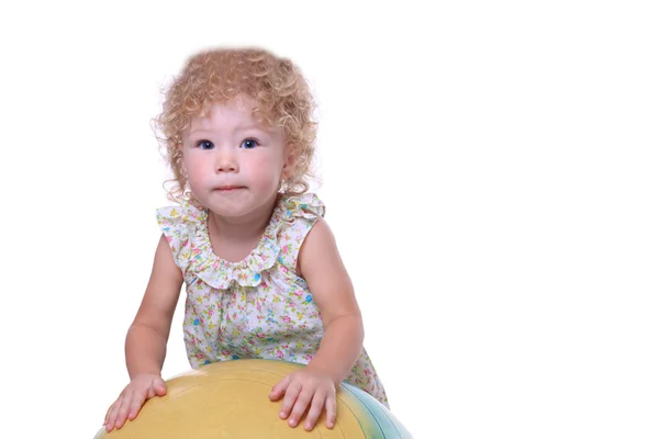 Baby holds gymnastic ball. — Stock Photo, Image