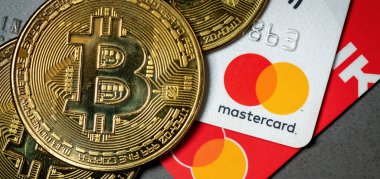 Antalya, Turkey - November 1, 2021: Bitcoin cryptocurrency standing on a MasterCard credit card. clipart