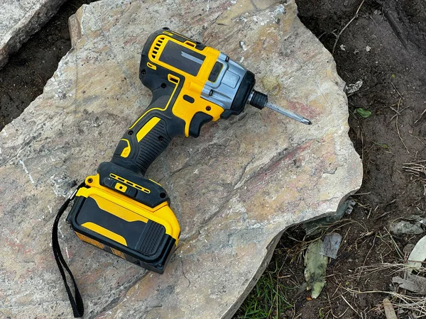 Cordless Screwdriver Standing Rock Ground Construction Site — Foto Stock